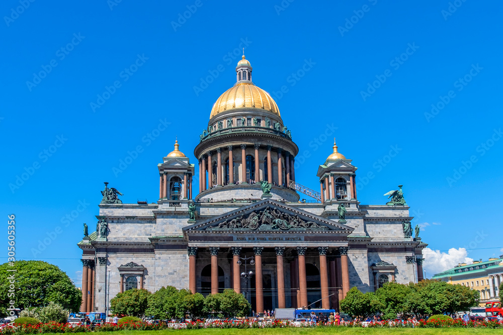 St. Isaac's Cathedral, a neoclassical Church with golden great dome against blue sky, in Saint-Petersburg, Russia.