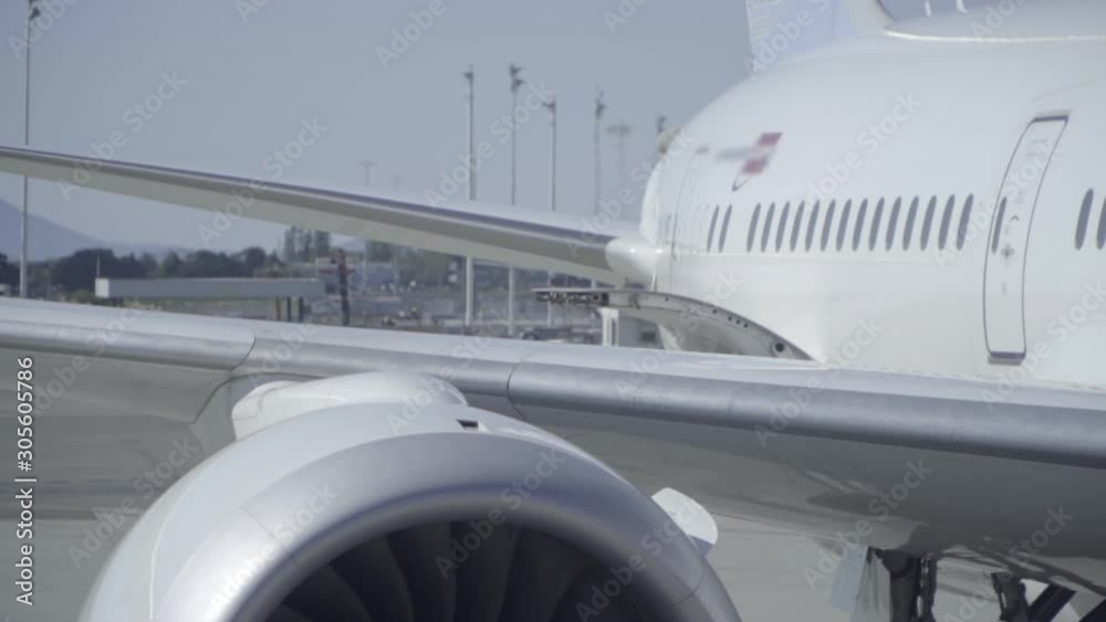 Close Up of Airplane Exhaust and Jet Turbine Spinning While Plane is Parked at Terminal Close Up of Airplane Exhaust and Jet Turbine Spinning While Plane is Parked at Terminal