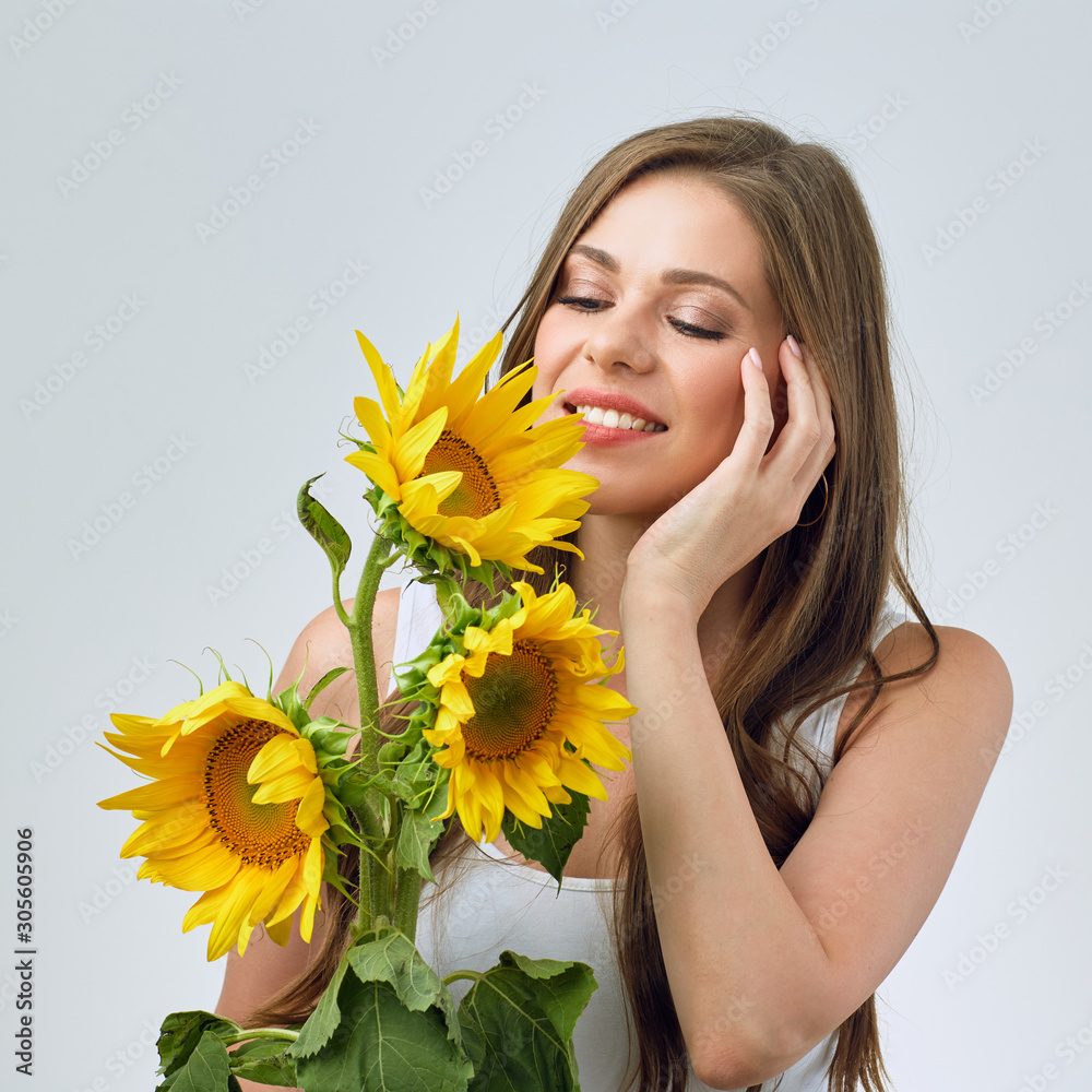 portrait of happy woman with closed eyes holding sunflowers . portrait of happy woman with closed eyes holding sunflowers .