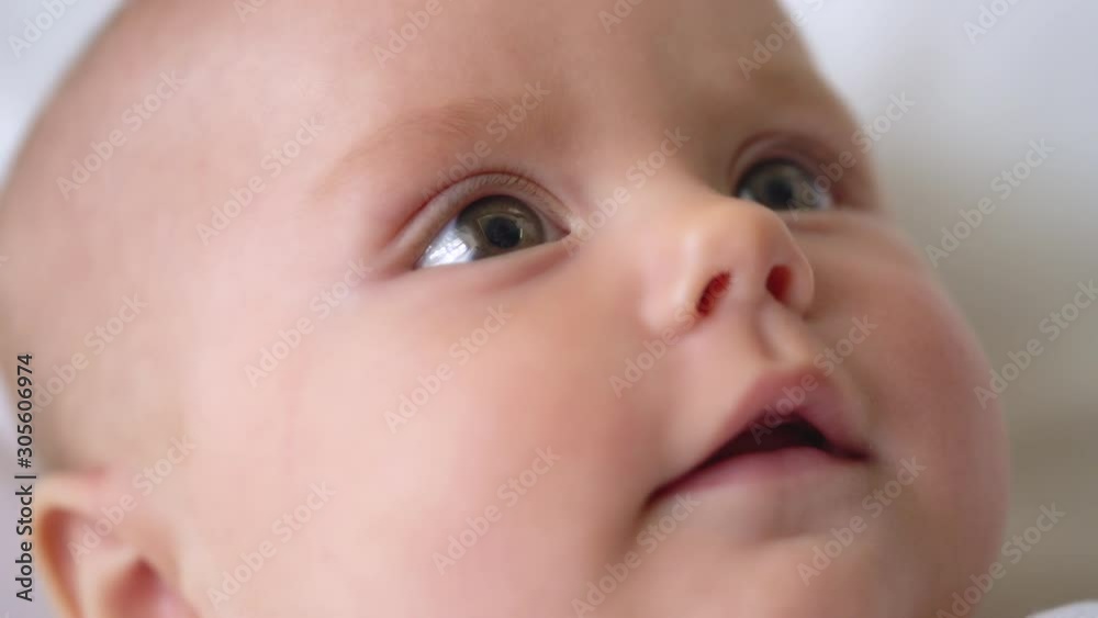 Cute baby face close up, infant looking at parents, prenatal care, adoption Cute baby face close up, infant looking at parents, prenatal care, adoption
