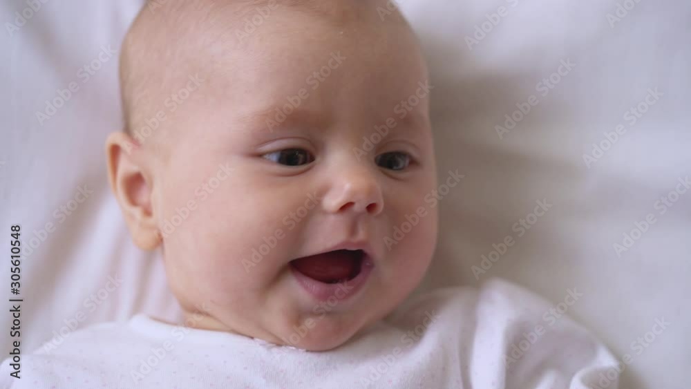 Happy smile on adorable baby face, innocent eyes looking around, tenderness Happy smile on adorable baby face, innocent eyes looking around, tenderness
