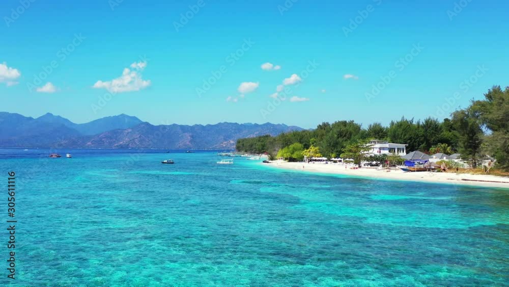 Coral Reef Under The Shallow Blue Sea Water Surrounding The Lush Island And White Sand With Beautiful Mountain Scenery In Bahamas -- Wide Shot Coral Reef Under The Shallow Blue Sea Water Surrounding The Lush Island And White Sand With Beautiful Mountain Scenery In Bahamas -- Wide Shot