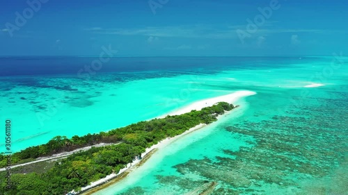 Blackadore Caye In Belize, Caribbean Island - Tropical Paradise Of Green Trees On Long Desolate Sandbar With Stunning Scenery Of Coral Reefs Under The Bright Blue Shallow Sea Water - Aerial Shot photo