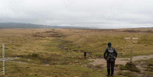 A walker looking out towards Pen-y-ghent in the Yorkshire Dales