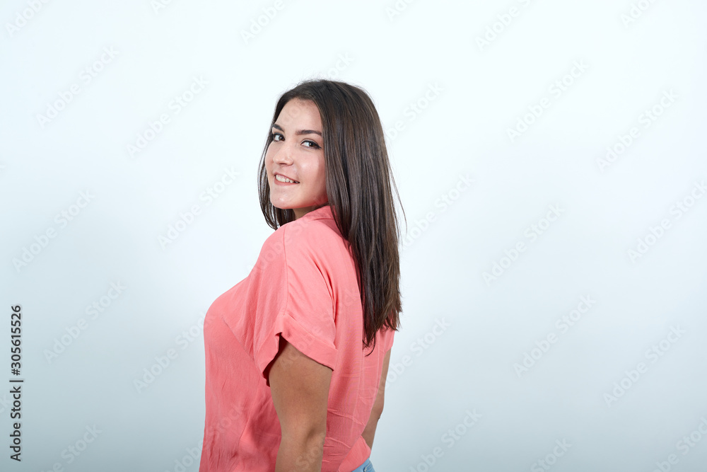 Attractive caucasian young woman in pink shirt posing , staying aside, looking pretty isolated on white background in studio. People sincere emotions, lifestyle concept. Attractive caucasian young woman in pink shirt posing , staying aside, looking pretty isolated on white background in studio. People sincere emotions, lifestyle concept.