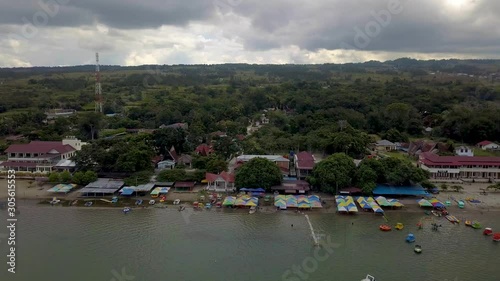 Aerial view of white sands beach known as Pantai Pasir Putih Parbaba, located in Samosir Island, Indonesia.