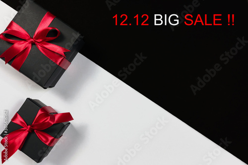 Online shopping of China.,Top view of black christmas gift boxes with red ribbon and text on black and white background with copy space for text., 12.12 single day sale concept and advertisement. © pongsakrit