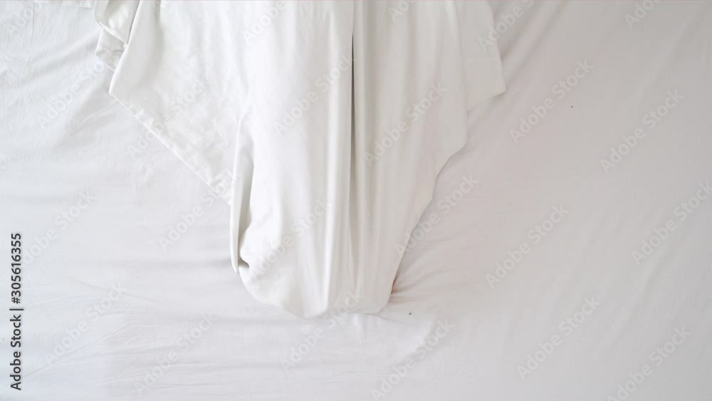 Medium shot from above of woman uncovering the foots during the morning.