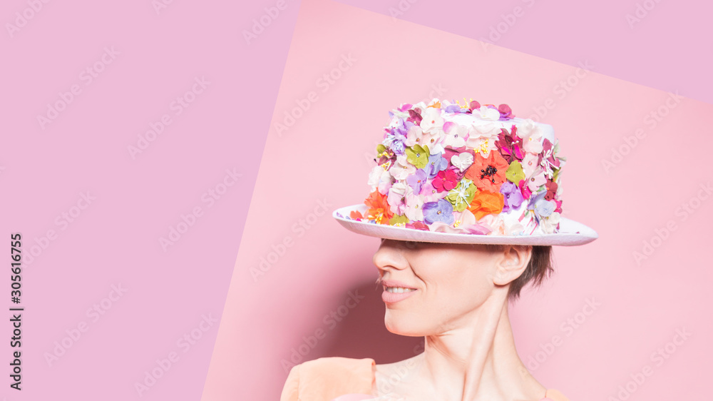 Fashion portrait of a young woman woman wearing stylish accessories. Hidden eyes with floral hat. Female fashion, beauty and advertisement Fashion portrait of a young woman woman wearing stylish accessories. Hidden eyes with floral hat. Female fashion, beauty and advertisement