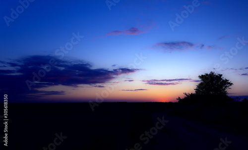 sunset and clouds over field