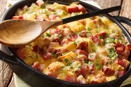 Fotografie Traditional american strata with ham, bread, onions, cheese and eggs close-up