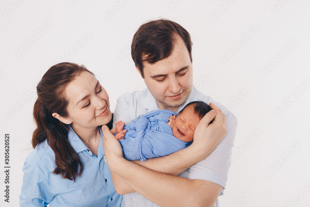 the concept of a healthy lifestyle, the protection of children, shopping - baby in the arms of the mother and wather. Woman and man holding a child the concept of a healthy lifestyle, the protection of children, shopping - baby in the arms of the mother and wather. Woman and man holding a child
