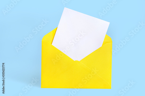Yellow envelope with blank card on blue background