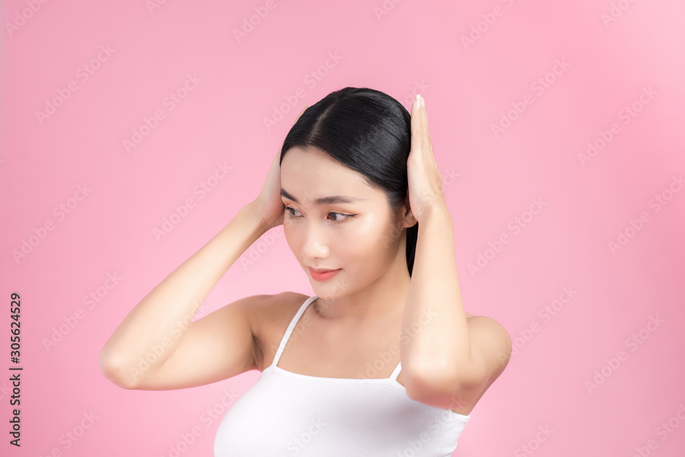 Beautiful Asian woman portrait with long healthy straight and shiny hair touching her hair hand. Hairstyle loose hair. Isolated on pink background Beautiful Asian woman portrait with long healthy straight and shiny hair touching her hair hand. Hairstyle loose hair. Isolated on pink background