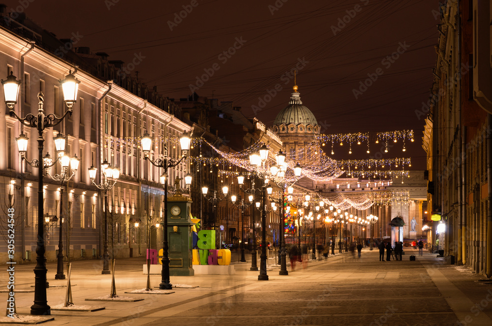 Beautiful night Christmas landscape with a view of Kazan Cathedral and blurred movement of people on a long exposition (St. Petersburg, Russia)