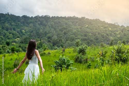 happy girl in a spring field, enjoying nature, beautiful woman in meadow,Freedom concept background.