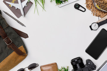 Top view mockup of Traveler's accessories with passport, books of travel plan, wallet, camera, hat, backpack and airplane toy isolated white background with empty space,Tropical travel concept