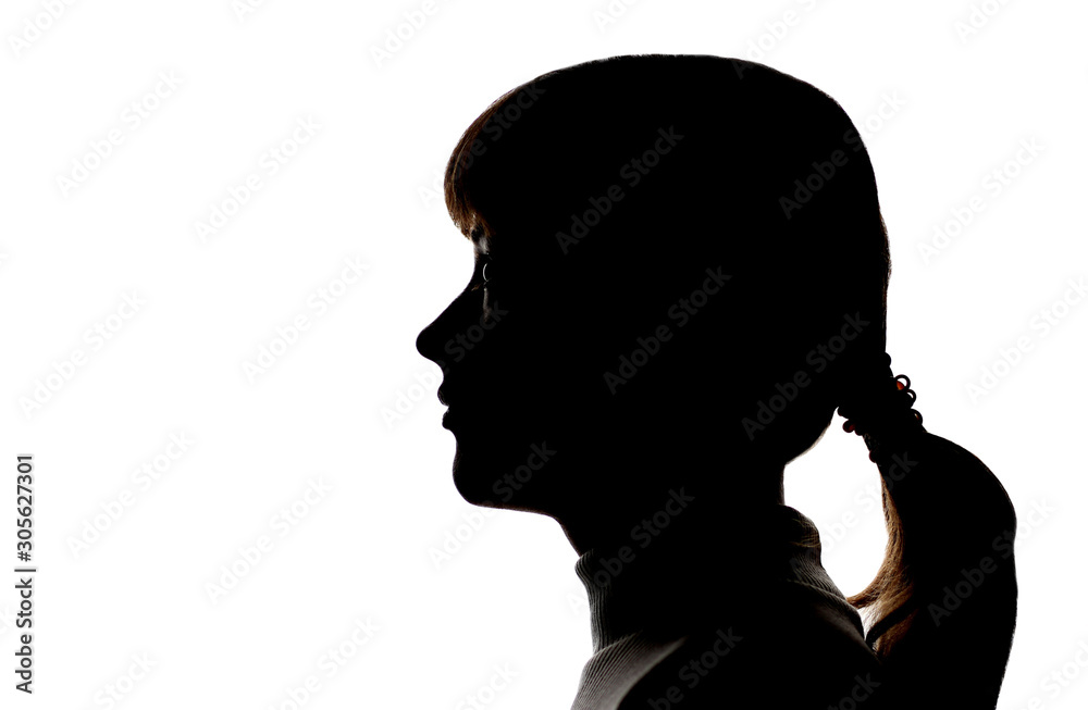 Dark silhouette profile of a young girl on white background, side view