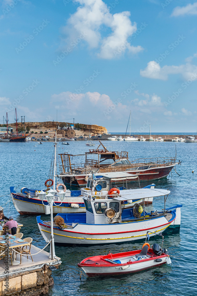 view of small boats in the harbor in the Greek resort town of Hersonissos