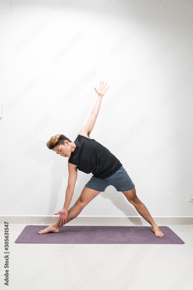 A man doing yoga exercises. Studio shot over white background. A man doing yoga exercises. Studio shot over white background.