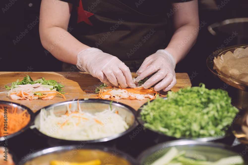 Vietnamese street food on the market in Vietnam. Spring Roll Cooking. Asian food cooking