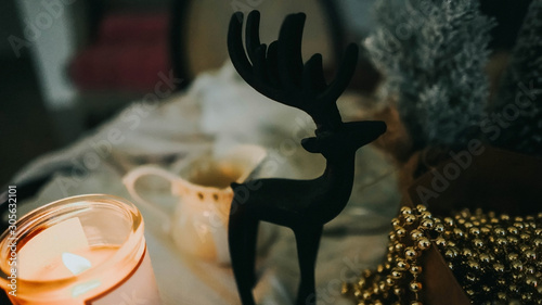 Black deer statuette, china teaspot. Christmas flat lay photo