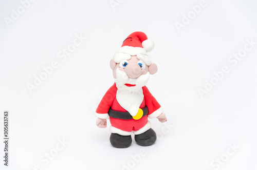 Santa Claus figurine. Toy Santa on white background. Christmas and New Year holidays concept. Closeup © Володимир Захаров