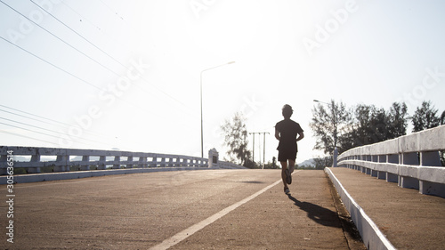 Asian male runner is start jogging on the street in the morning