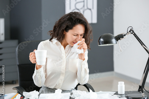 Woman ill with flu working ...