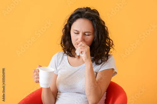 Woman ill with flu drinking...