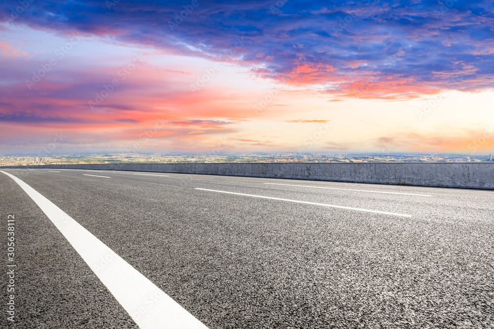 Shanghai city skyline and empty asphalt road scenery at sunset.