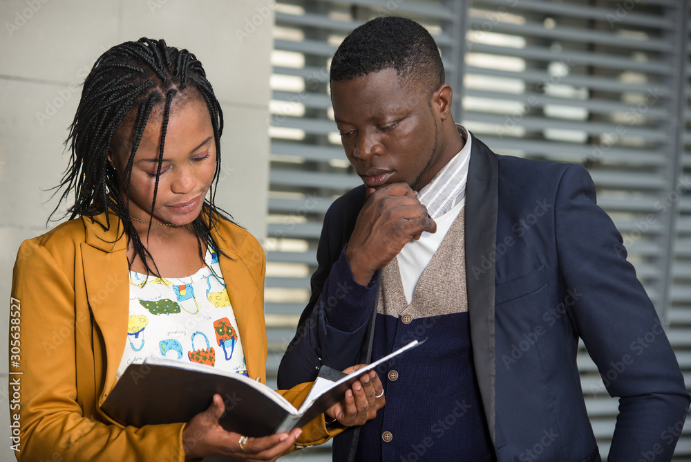Image of two happy businessmen looking at a business plan Image of two happy businessmen looking at a business plan