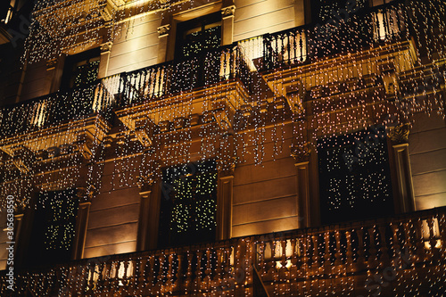 Photography beautiful historic building in Barcelona decorated with numerous garlands