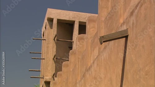 Extreme close-up low angle still shot against the blue sky of a wind tower or wind catcher of a traditional building. The tower openings allowed for air movements through buildings for effective photo