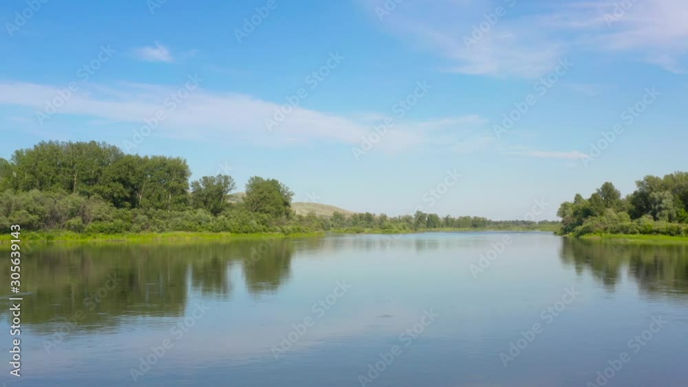 The long arms of the wild fresh river bed stretched along the beautiful mountains and green fields The long arms of the wild fresh river bed stretched along the beautiful mountains and green fields