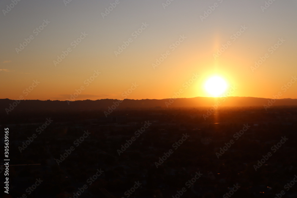 Fototapeta premium Sun Setting Behind a Mountain 