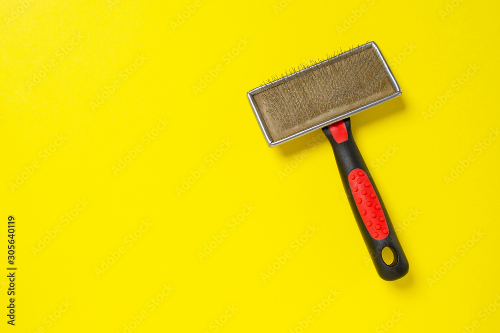 Grooming brush, or professional comb for dog on bright yellow background. Grooming brush, or professional comb for dog on bright yellow background.