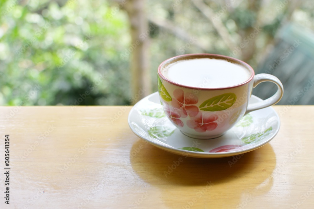 Hot coffee cup with spoon put on wood table with blur background, refreshment on morning time, relaxing in the coffee shop, Hot coffee cup with spoon put on wood table with blur background, refreshment on morning time, relaxing in the coffee shop,