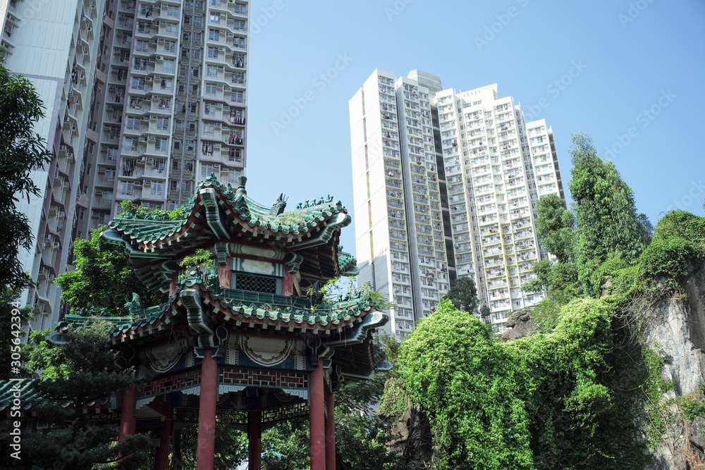 Closeup temple pavilion in Chinese style with crowd of high building and cityscape in background
