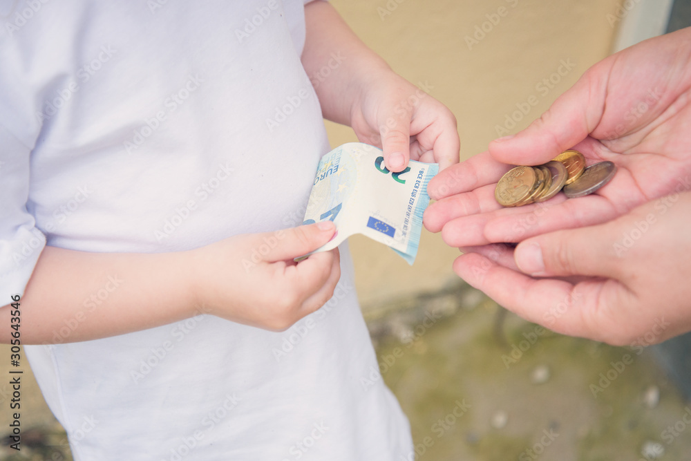 adult and child hands with money
