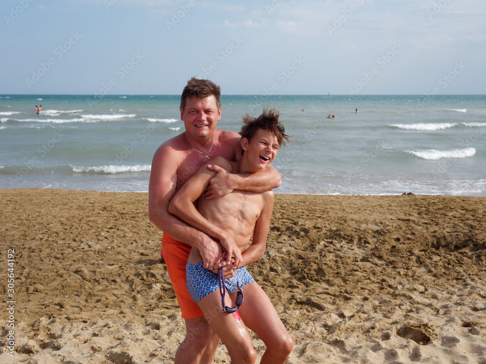 Father with son at the beach in Bibione, Italy