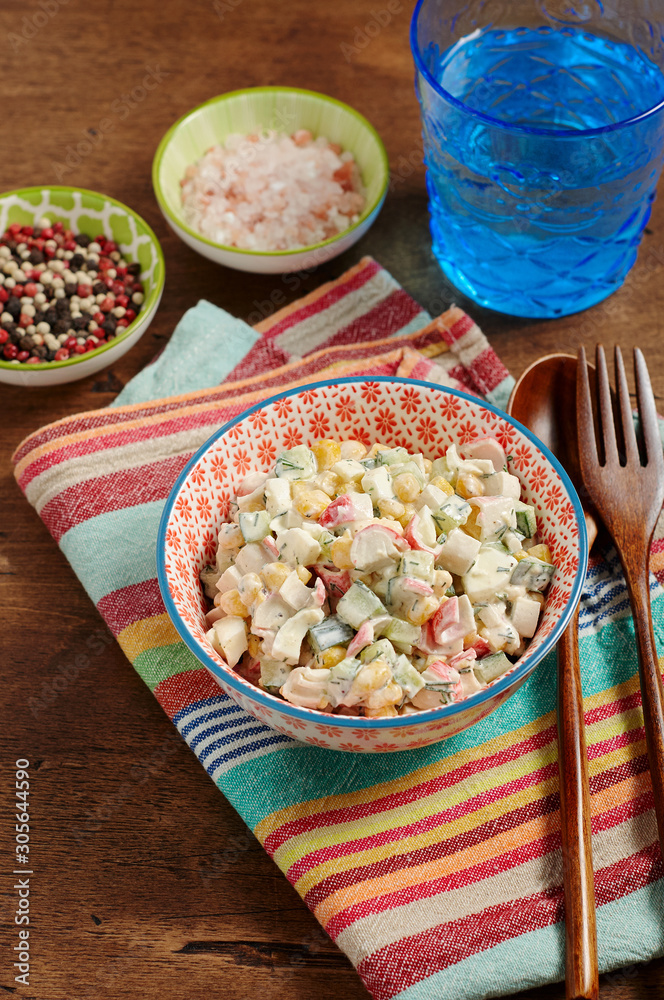 Bowl of Surimi Seafood Salad with sweet corn, cucumbers, boiled eggs and mayonnaise