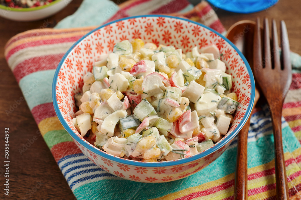 Bowl of Surimi Seafood Salad with sweet corn, cucumbers, boiled eggs and mayonnaise