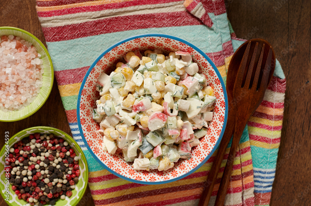 Bowl of Surimi Seafood Salad with sweet corn, cucumbers, boiled eggs and mayonnaise