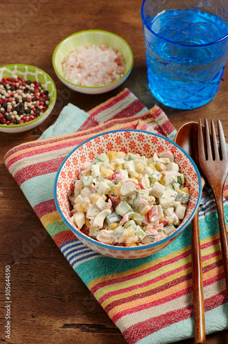 Obraz na płótnie Bowl of Surimi Seafood Salad with sweet corn, cucumbers, boiled eggs and mayonnaise w salonie