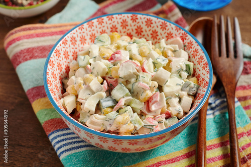 Obraz na płótnie Bowl of Surimi Seafood Salad with sweet corn, cucumbers, boiled eggs and mayonnaise w salonie