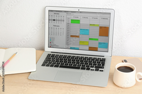Modern laptop with calendar app in office