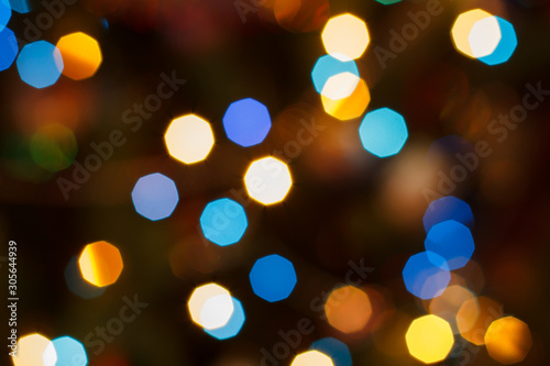 Christmas blurred background with colorful festive lights.