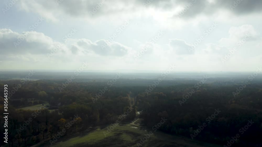 The drone flies slowly backwards on a sunny, cloudy and moody day, revealing a beautiful landscape with field and forest, as well as aesthetic fog on a sunny day. The drone flies slowly backwards on a sunny, cloudy and moody day, revealing a beautiful landscape with field and forest, as well as aesthetic fog on a sunny day.