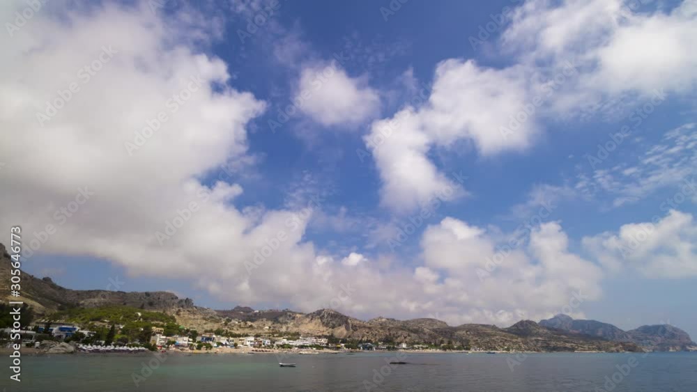 Greece Rhodes island. Idyllic sea coast landscape with blue sky and white clouds in morning light. 4K Time Lapse. Taken in Stegna.